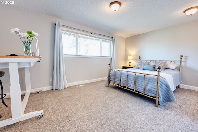 carpeted bedroom featuring a textured ceiling