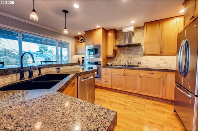 kitchen featuring stainless steel appliances, light hardwood / wood-style floors, sink, wall chimney range hood, and decorative backsplash