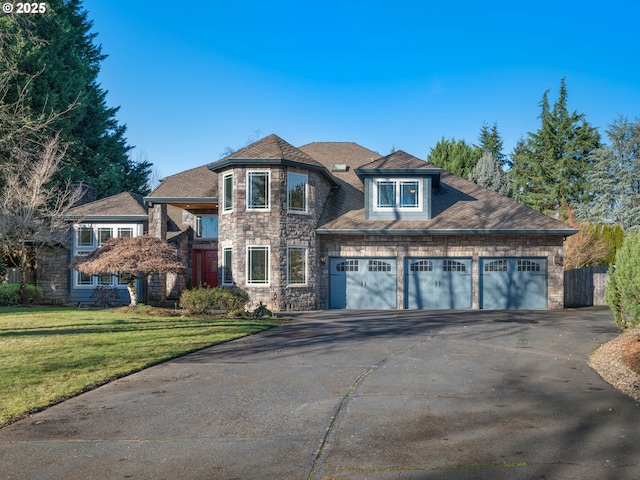 view of front of property featuring a garage and a front lawn