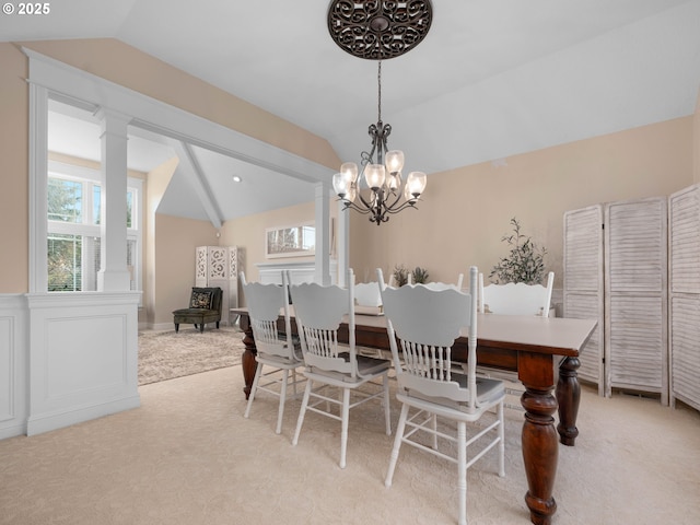 dining area with light carpet, vaulted ceiling, and a notable chandelier