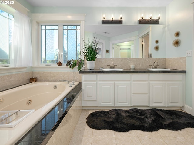 bathroom with tasteful backsplash, tiled tub, a wealth of natural light, and vanity