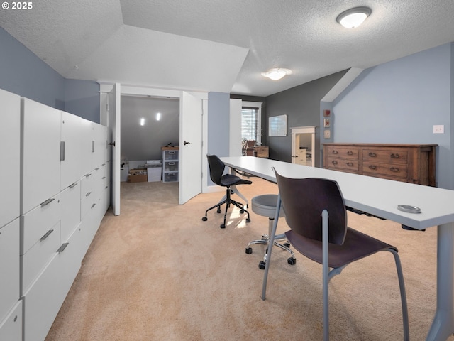 carpeted office space featuring a textured ceiling