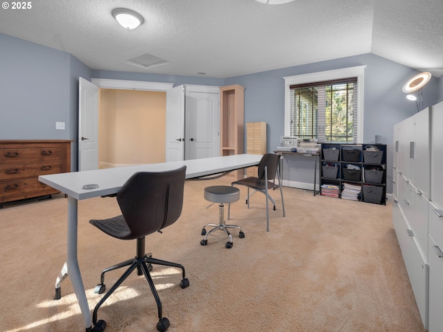 carpeted home office featuring lofted ceiling and a textured ceiling