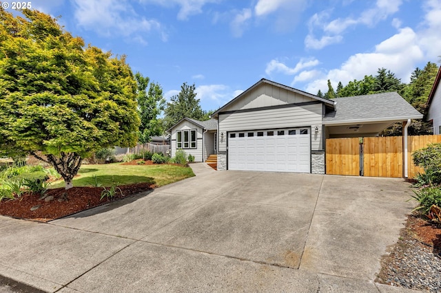 1633 N Q St, Washougal, WA 98671 - ranch-style home with stone siding, concrete driveway, and a garage