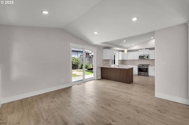 1633 N Q St, Washougal, WA 98671 - kitchen featuring appliances with stainless steel finishes, vaulted ceiling, open floor plan, light countertops, and white cabinetry