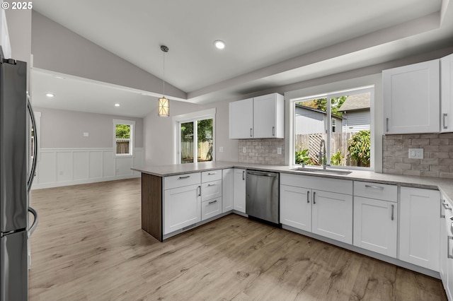 1633 N Q St, Washougal, WA 98671 - kitchen with dishwasher, freestanding refrigerator, a peninsula, healthy amount of natural light, and vaulted ceiling