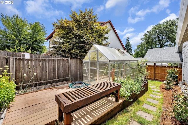 1633 N Q St, Washougal, WA 98671 - fenced backyard featuring a greenhouse, an outbuilding, a vegetable garden, and a wooden deck