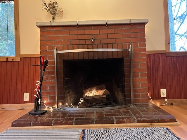 interior details featuring a brick fireplace and hardwood / wood-style floors