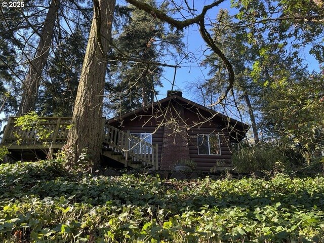 rear view of house with a wooden deck