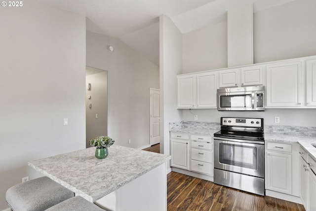 516 SE 8th Pl Unit H17, Battle Ground, WA 98604 - kitchen featuring appliances with stainless steel finishes, a kitchen island, white cabinetry, and dark wood-type flooring