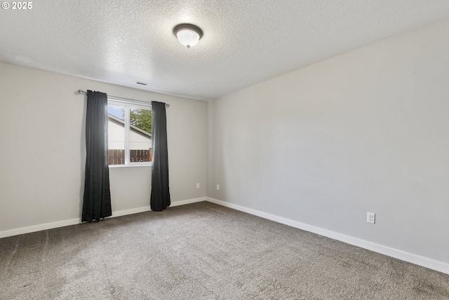 516 SE 8th Pl Unit H17, Battle Ground, WA 98604 - empty room with carpet floors, baseboards, a textured ceiling, and visible vents