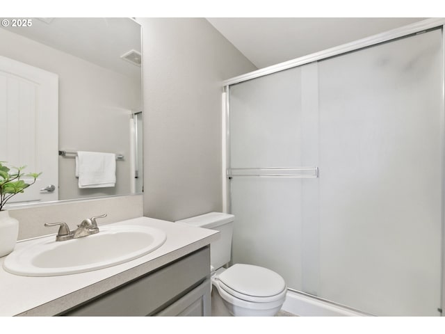 full bathroom with toilet, visible vents, a shower stall, and vanity