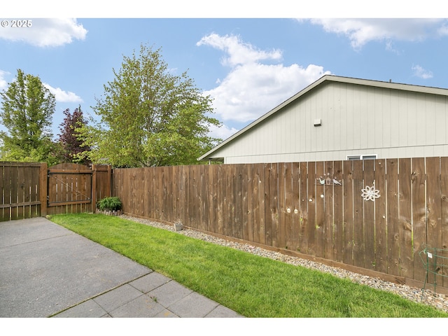 view of yard featuring fence and a gate