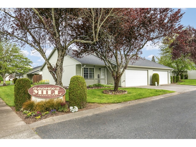 ranch-style home with a garage, a porch, driveway, and a front lawn