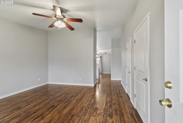 516 SE 8th Pl Unit H17, Battle Ground, WA 98604 - empty room featuring dark wood-type flooring, a ceiling fan, and baseboards