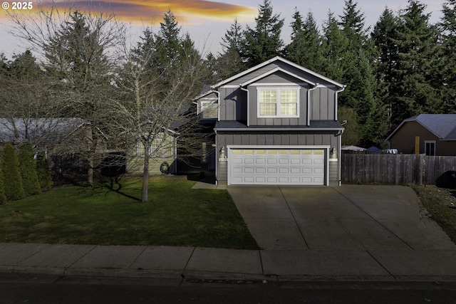 traditional-style home with an attached garage, board and batten siding, a front yard, fence, and driveway