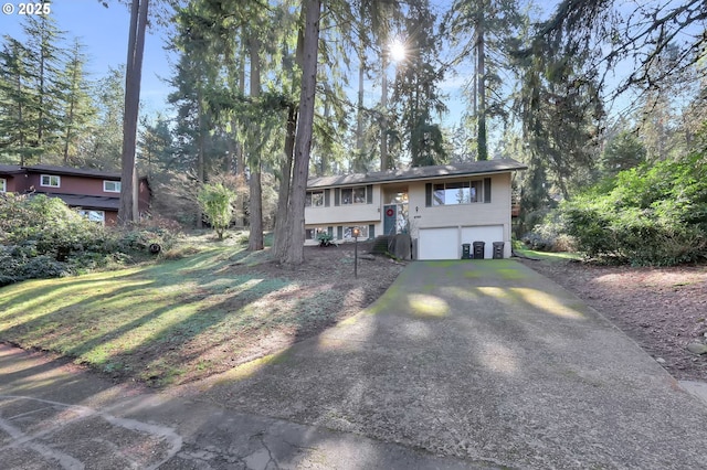 bi-level home featuring a garage and driveway