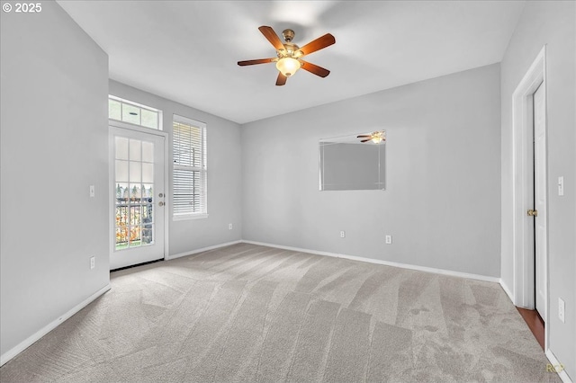 empty room featuring baseboards, carpet, and ceiling fan