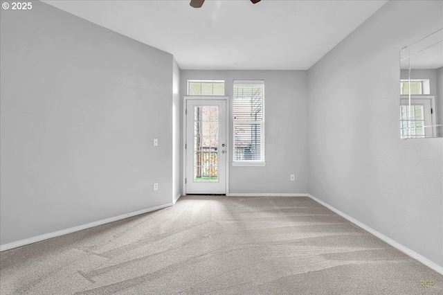 unfurnished room featuring ceiling fan, baseboards, and carpet