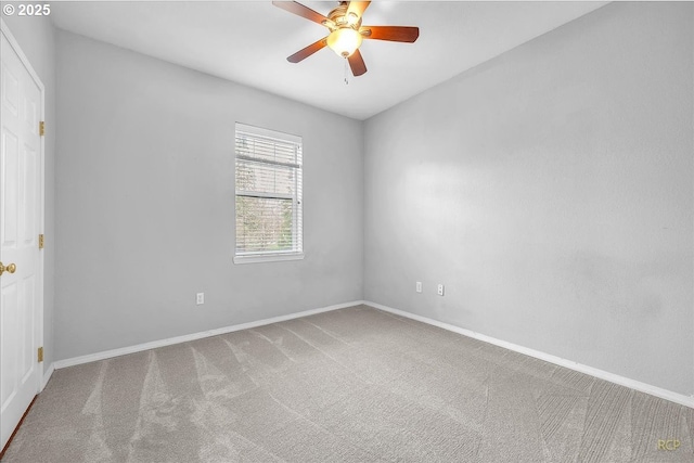 carpeted empty room featuring baseboards and ceiling fan