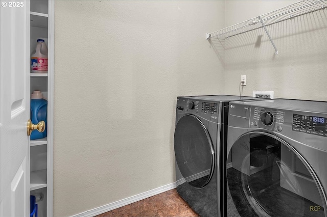 laundry room featuring laundry area, baseboards, and separate washer and dryer