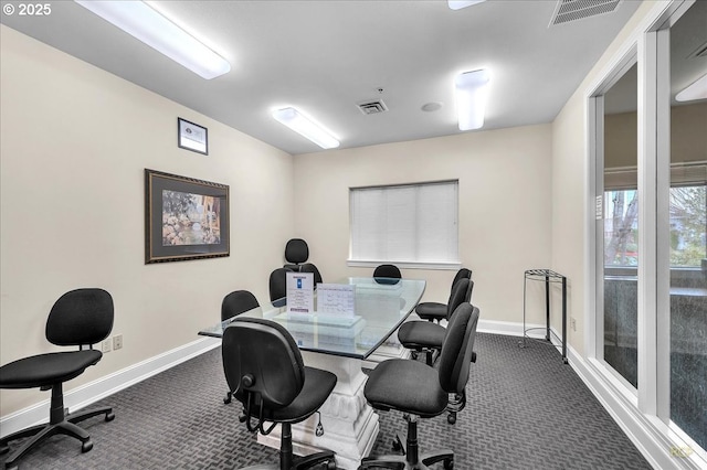 office with dark colored carpet, visible vents, and baseboards