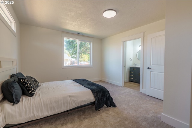 535 E St, Independence, OR 97351 - bedroom with multiple windows, carpet, a textured ceiling, and ensuite bath