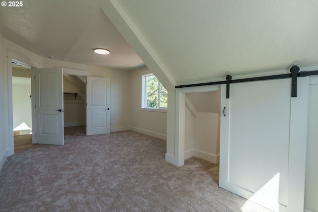 535 E St, Independence, OR 97351 - unfurnished bedroom with carpet flooring and a barn door