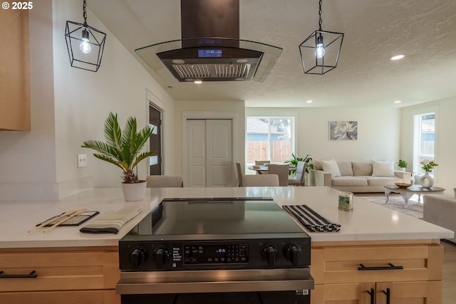 535 E St, Independence, OR 97351 - kitchen with stainless steel range with electric cooktop, extractor fan, open floor plan, light countertops, and light brown cabinets