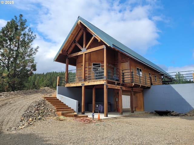 rear view of property featuring stairway