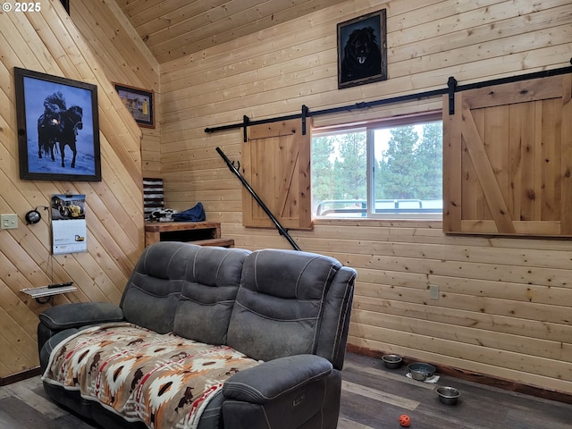 sitting room with wood ceiling, wood walls, a barn door, and wood finished floors