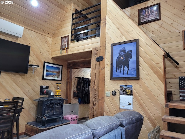 living area with a wood stove, wood ceiling, lofted ceiling, and wooden walls