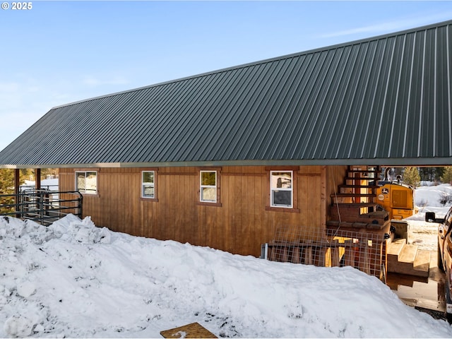view of snow covered exterior featuring metal roof