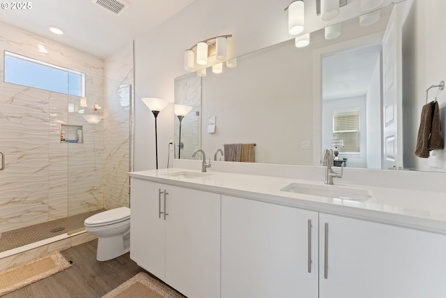 8229 SE Kinnaman St, Hillsboro, OR 97123 - bathroom featuring double vanity, a marble finish shower, toilet, and wood finished floors
