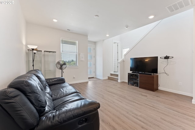 8229 SE Kinnaman St, Hillsboro, OR 97123 - living room featuring light wood-style flooring, stairs, baseboards, and recessed lighting