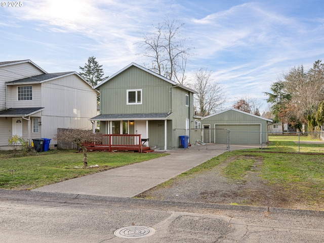 view of front of house with a front lawn, a garage, and an outdoor structure