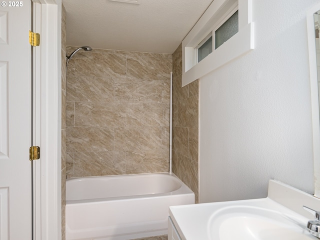 bathroom featuring vanity and tiled shower / bath combo