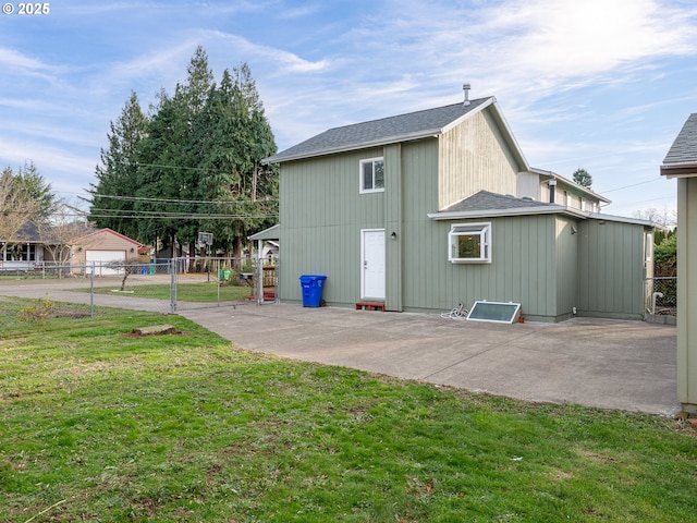 back of house featuring a patio area and a yard