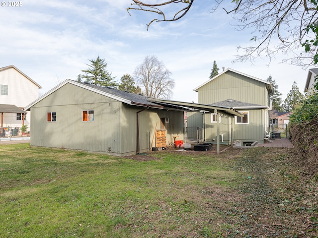 rear view of property with a lawn