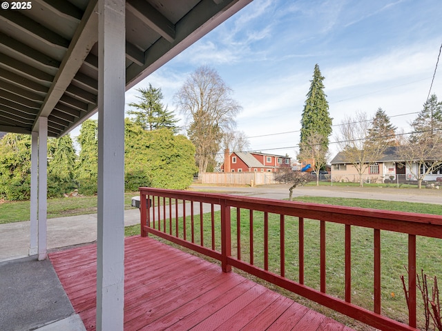 wooden deck with a lawn