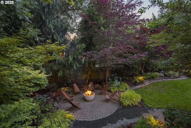 3946 SW Coronado St, Portland, OR 97219 - view of green lawn featuring an outdoor fire pit and a patio area