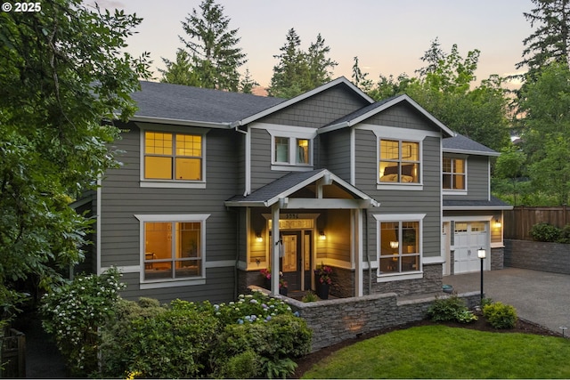 3946 SW Coronado St, Portland, OR 97219 - view of front of home with a garage, asphalt driveway, roof with shingles, and stone siding