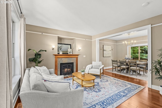 3946 SW Coronado St, Portland, OR 97219 - living area featuring a chandelier, wood finished floors, and a fireplace