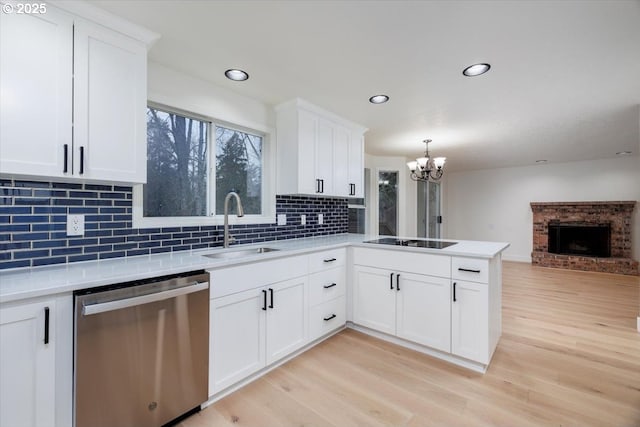 kitchen featuring dishwasher, white cabinetry, black electric cooktop, sink, and light hardwood / wood-style flooring