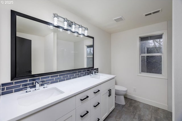 bathroom with toilet, decorative backsplash, and vanity