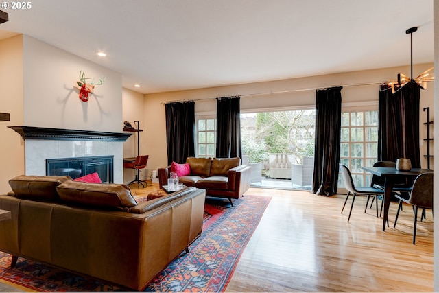 living area featuring recessed lighting, a fireplace, and wood finished floors