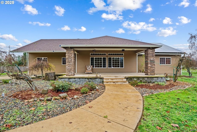 view of front of home with ceiling fan and a patio area