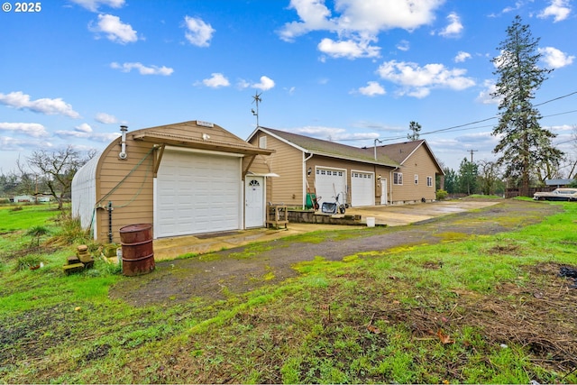 rear view of house featuring a garage