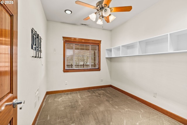 carpeted empty room featuring visible vents, ceiling fan, and baseboards