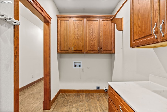 clothes washing area featuring hookup for a washing machine, cabinet space, hookup for an electric dryer, and wood finished floors